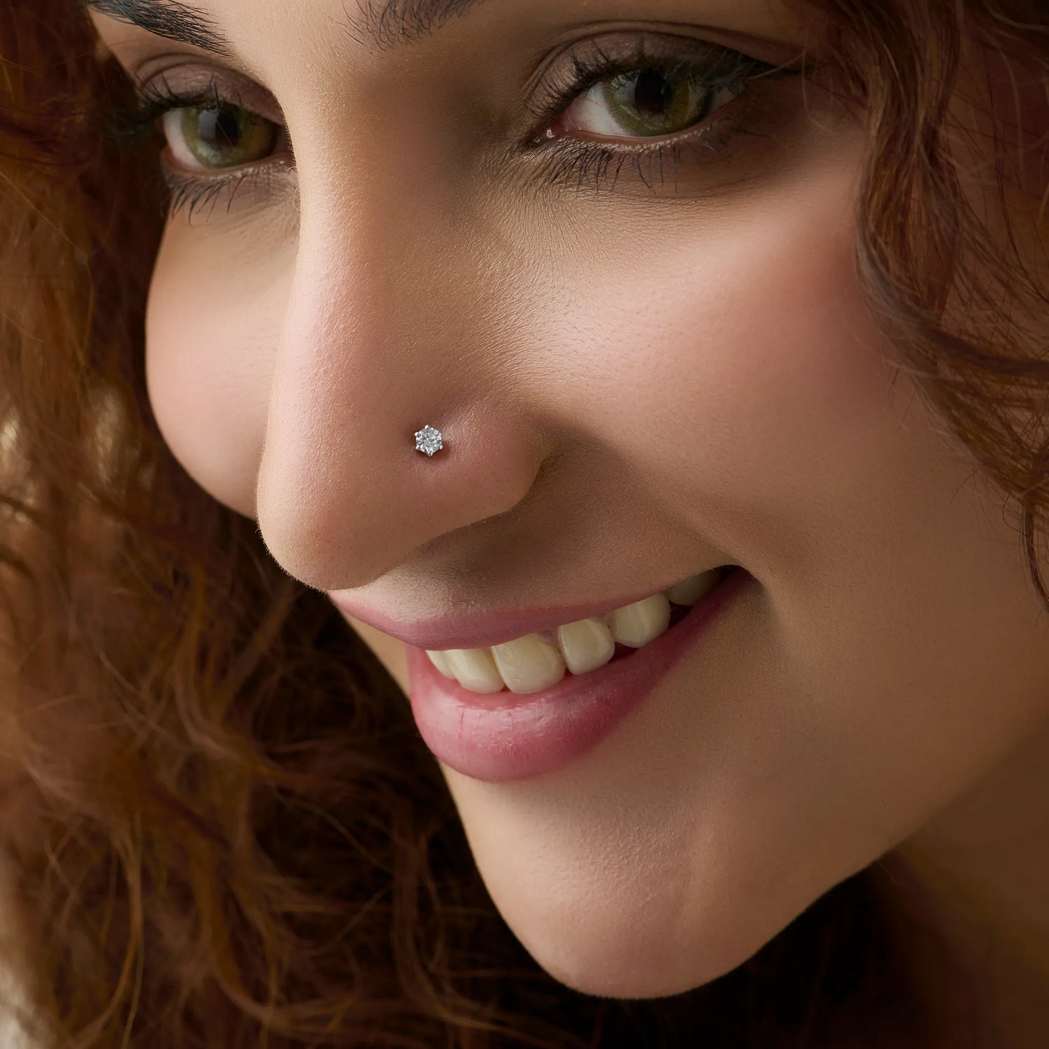 Model showcasing a simple solitaire diamond nose pin