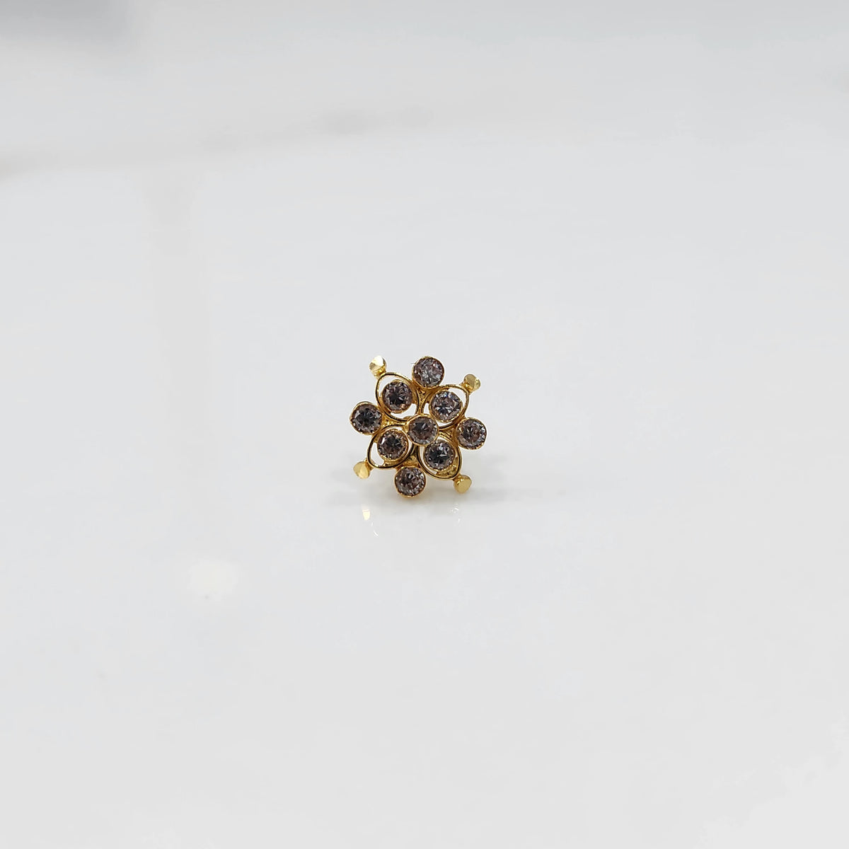 Small stone gold nose pin front view on white background
