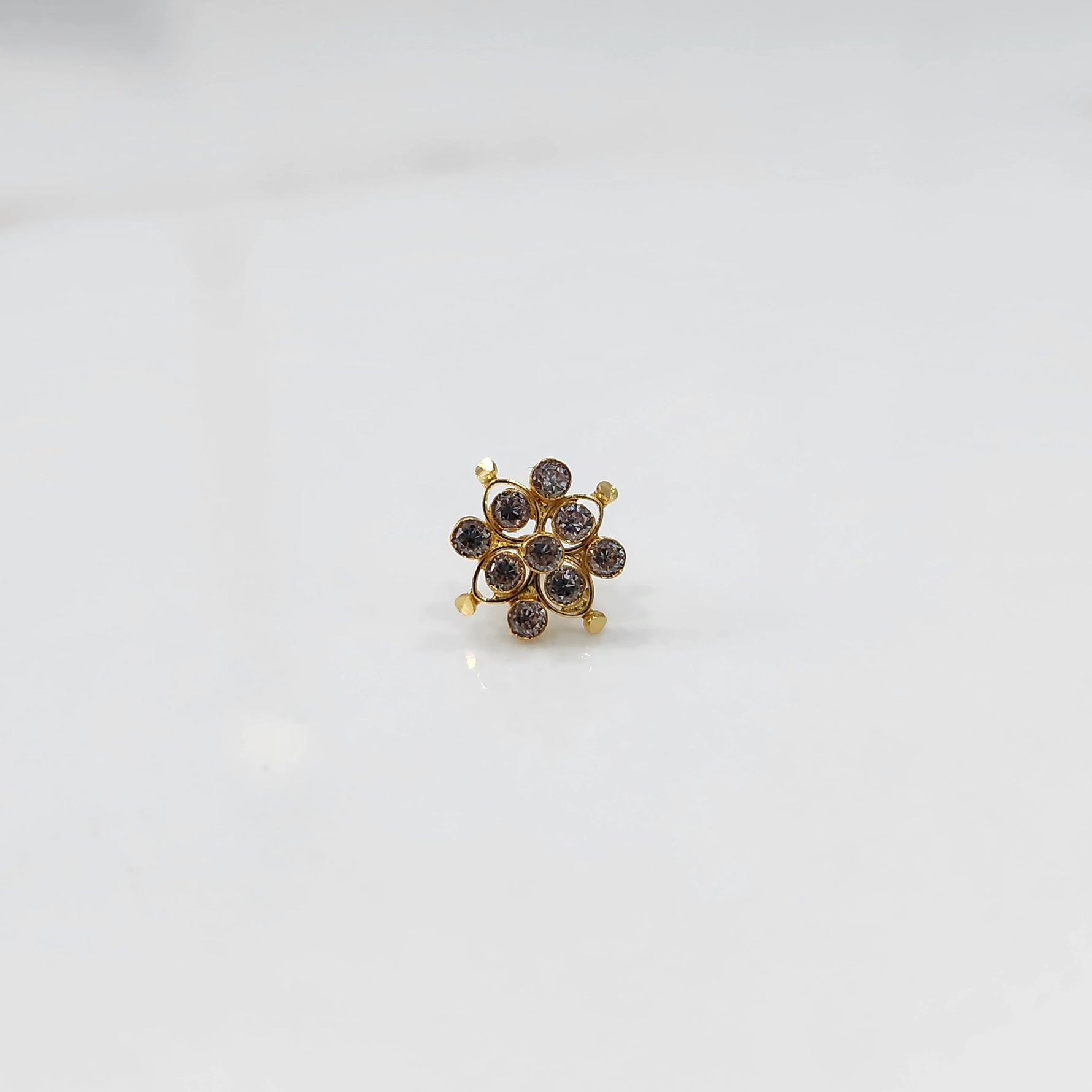 Small stone gold nose pin front view on white background