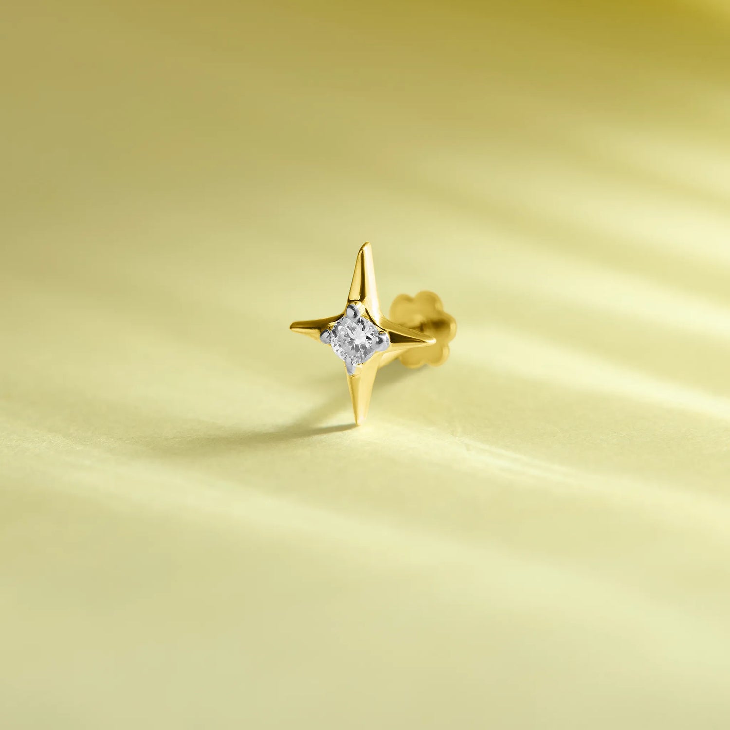 North star-shaped diamond stud earring in 14k gold