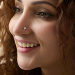 Woman wearing elegant flower gold nose pin close-up portrait