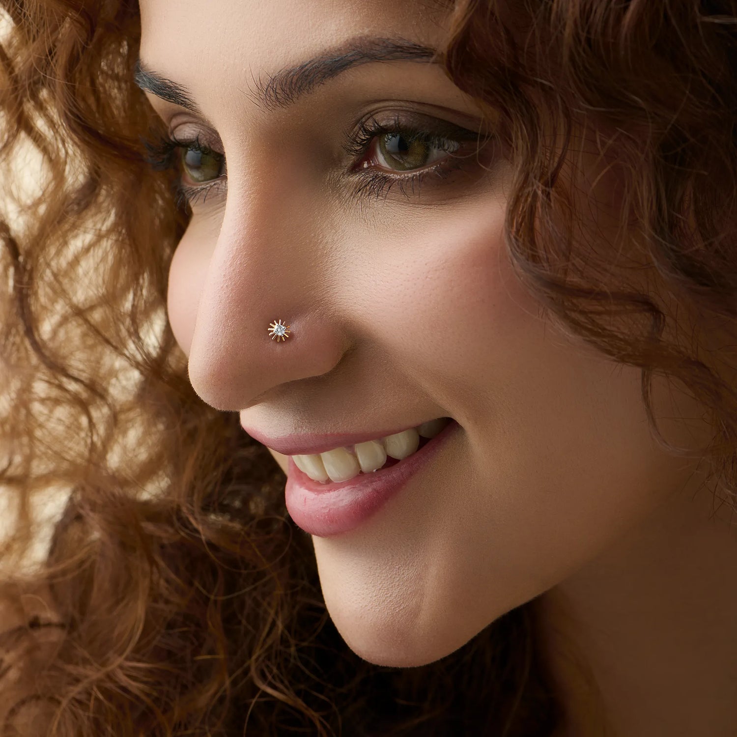 Woman wearing elegant gold diamond nose pin close-up portrait