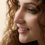 Woman wearing elegant solitaire lab grown diamond nose pin with minimal design