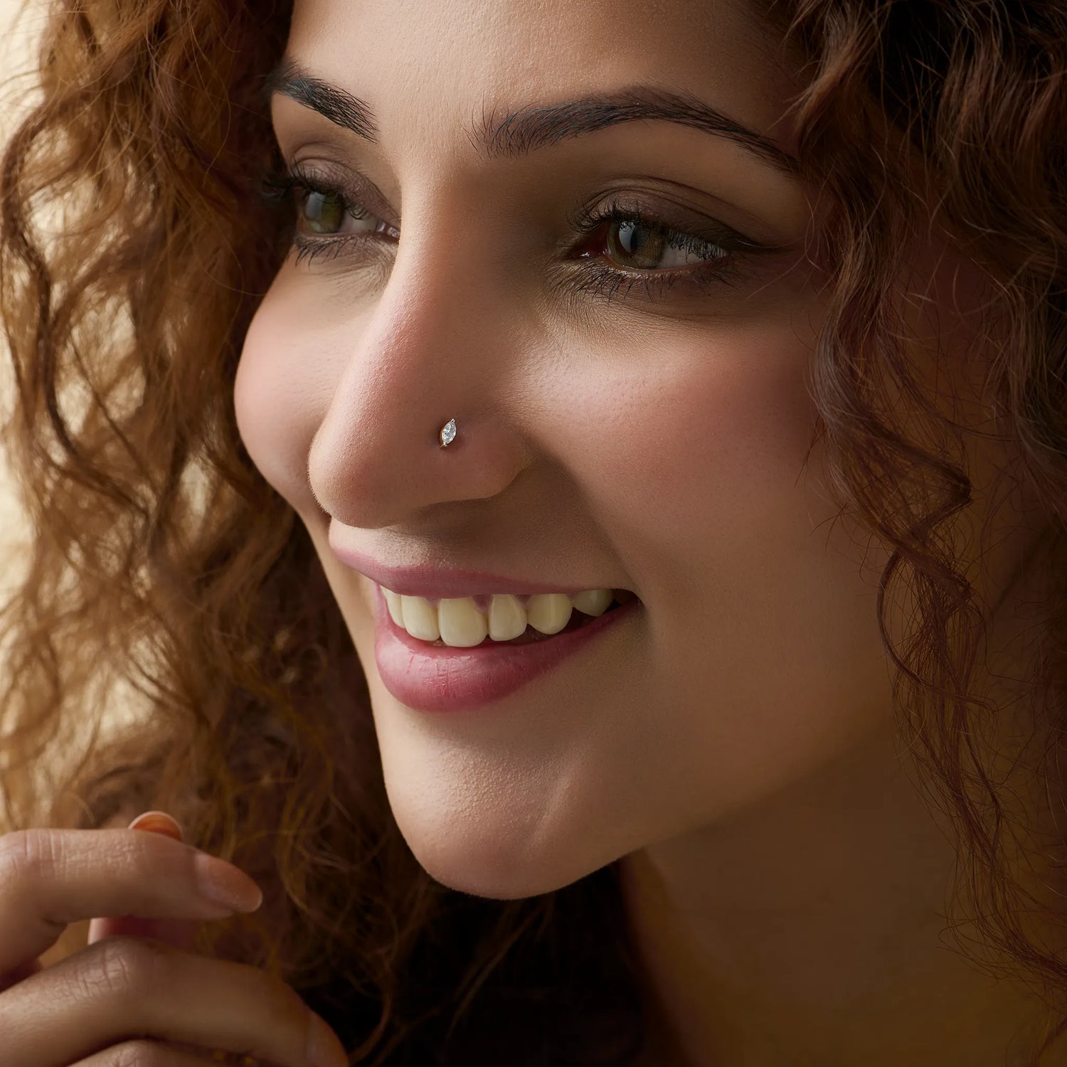 Woman wearing single stone nose pin gold with elegant solitaire diamond s