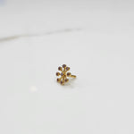 Sunburst diamond nose pin with gold spoke setting, jewelry photography