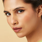 Model wearing Swirl Delight Gold Nose Ring in 18K gold showcasing elegant swirl design for a stylish traditional look