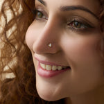 Woman wearing elegant gold diamond nose pin close-up portrait