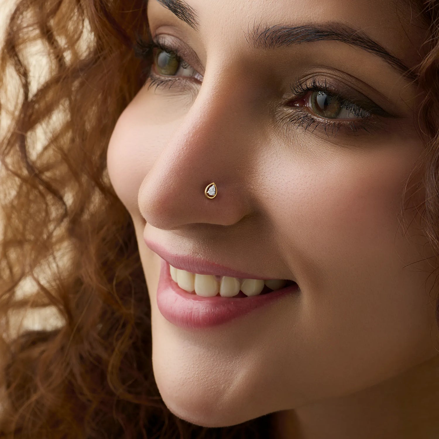 Woman wearing elegant gold diamond nose pin close-up portrait
