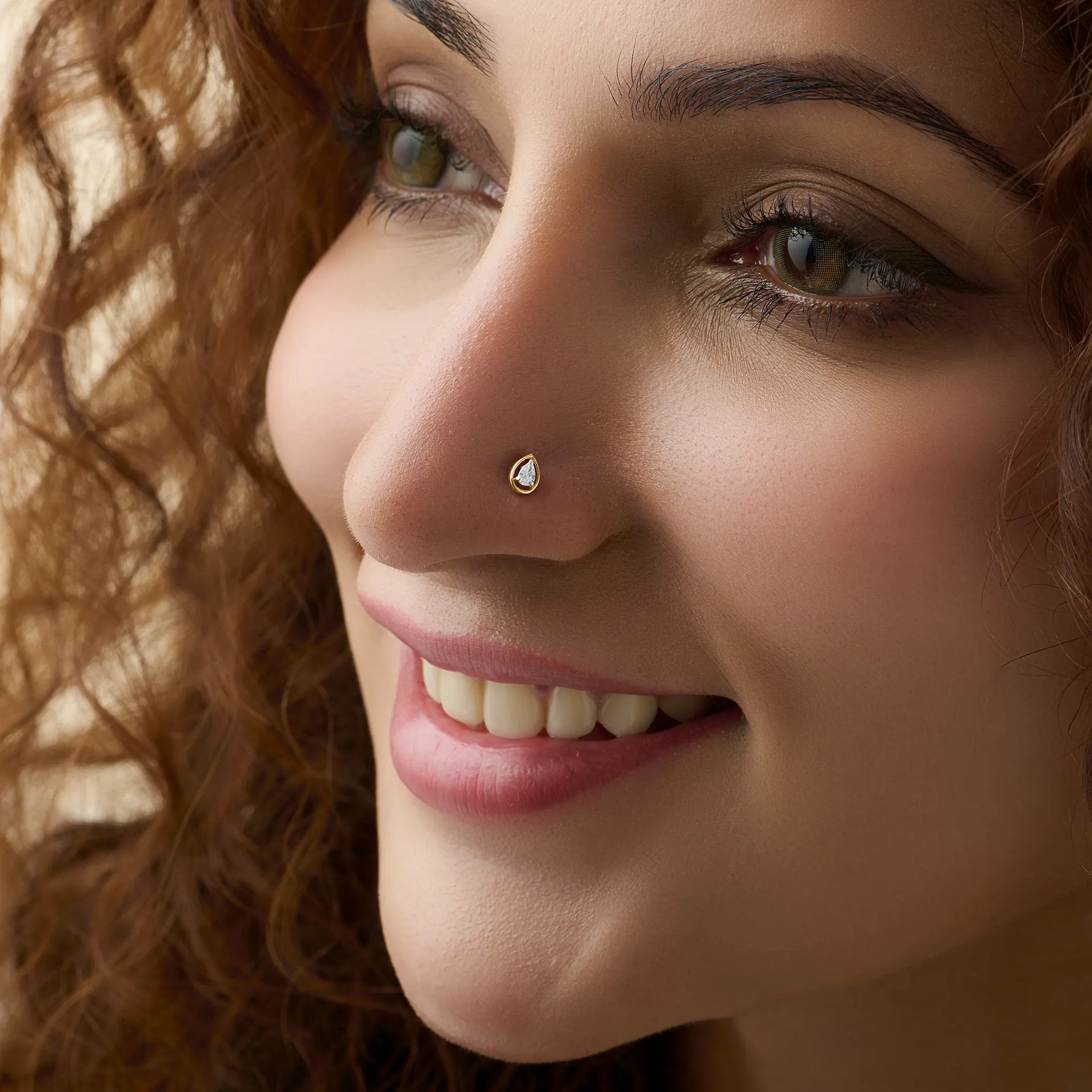 Woman wearing elegant gold diamond nose pin close-up portrait
