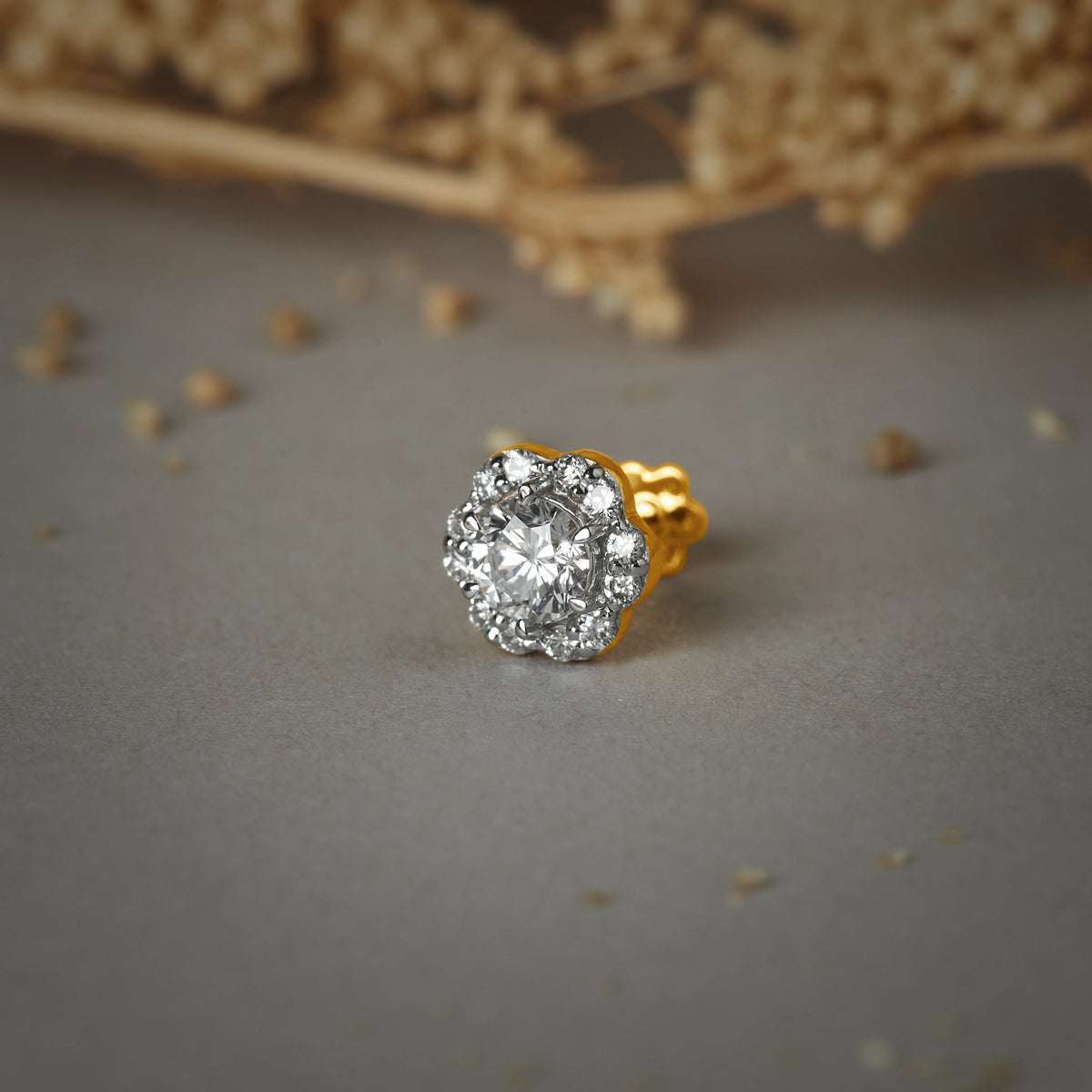 Stone Gold Nose Pin with a round cluster design featuring multiple sparkling stones set in gold on a soft neutral background