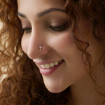 Model showcasing a delicate three-diamond cluster nose pin