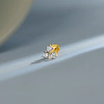 Gold floral diamond nose pin design on soft blue background