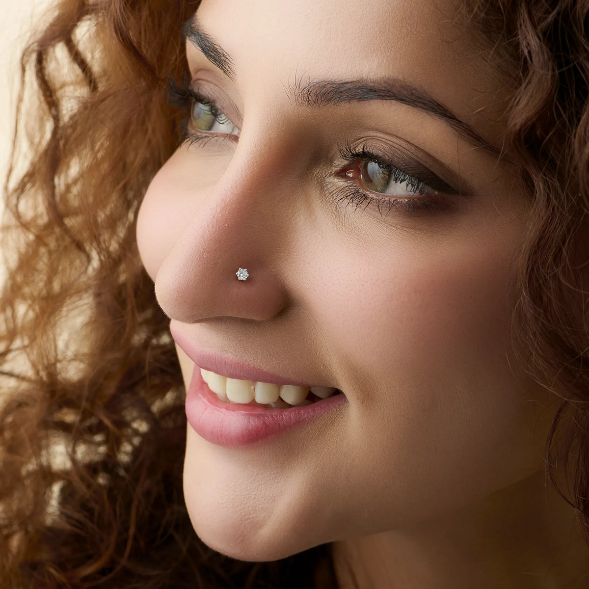 Model showcasing a small flower-set diamond nose pin