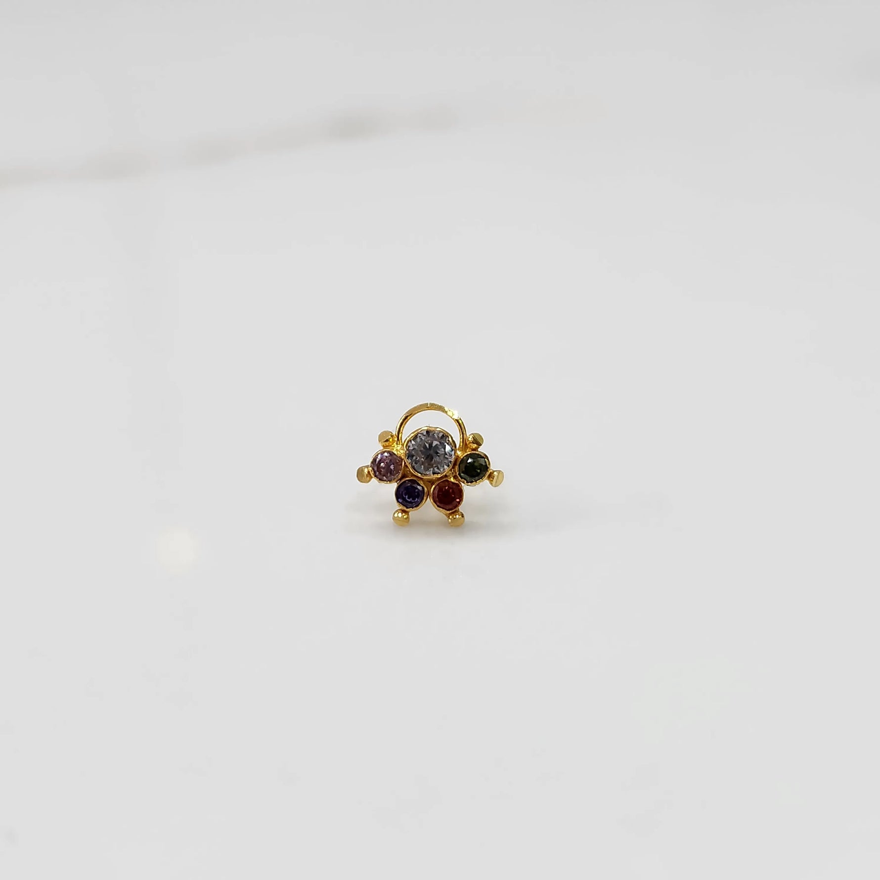 Gold ring with multicolor stone cluster in purple and clear tones