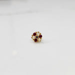 Top view of gold filigree ring with ruby-red oval gemstones