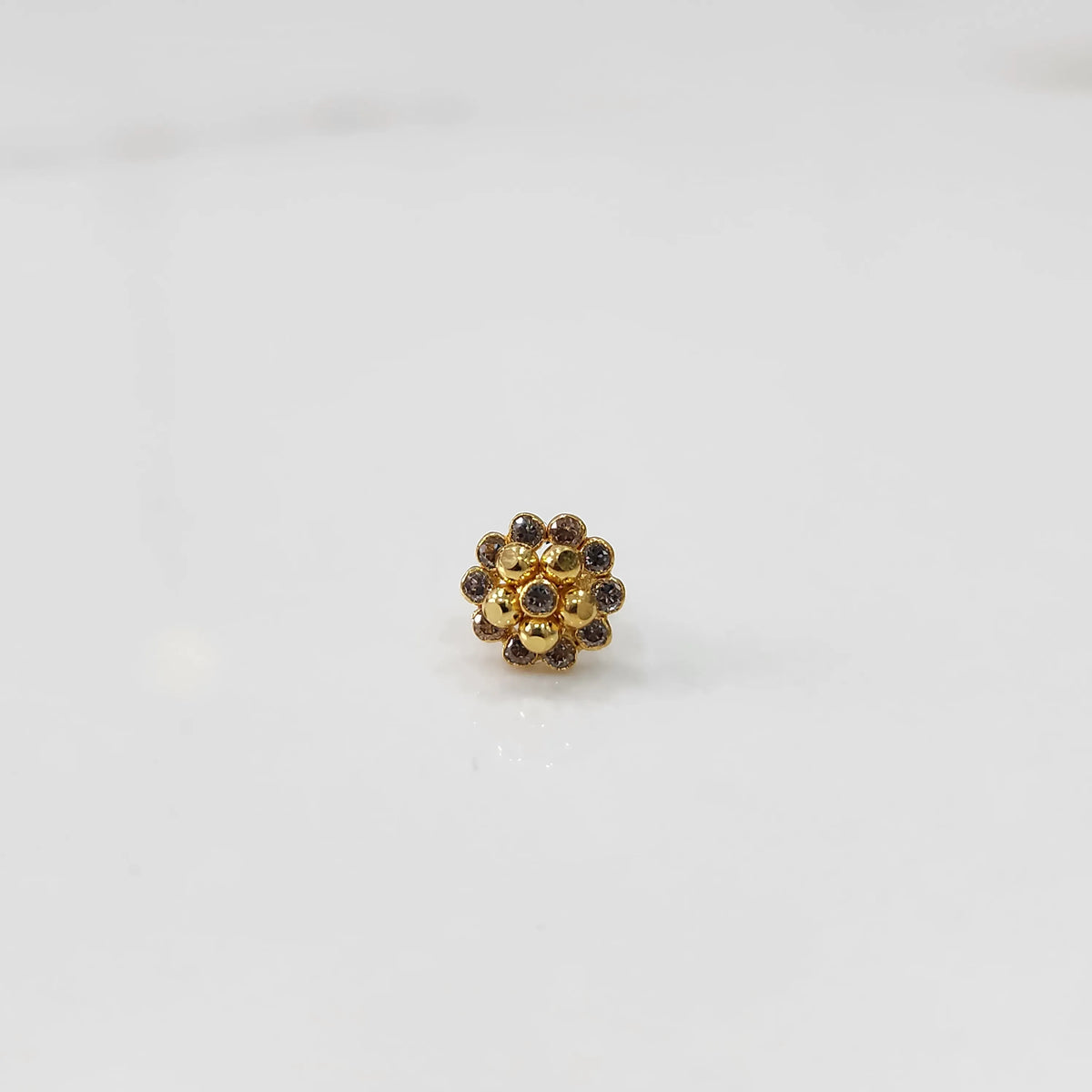 Gold floral cluster ring with champagne and clear stone detailing