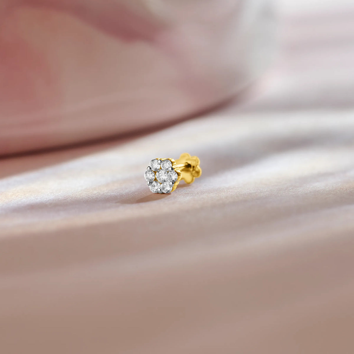 Solitaire lab grown diamond nose pin with round stone on soft pink background