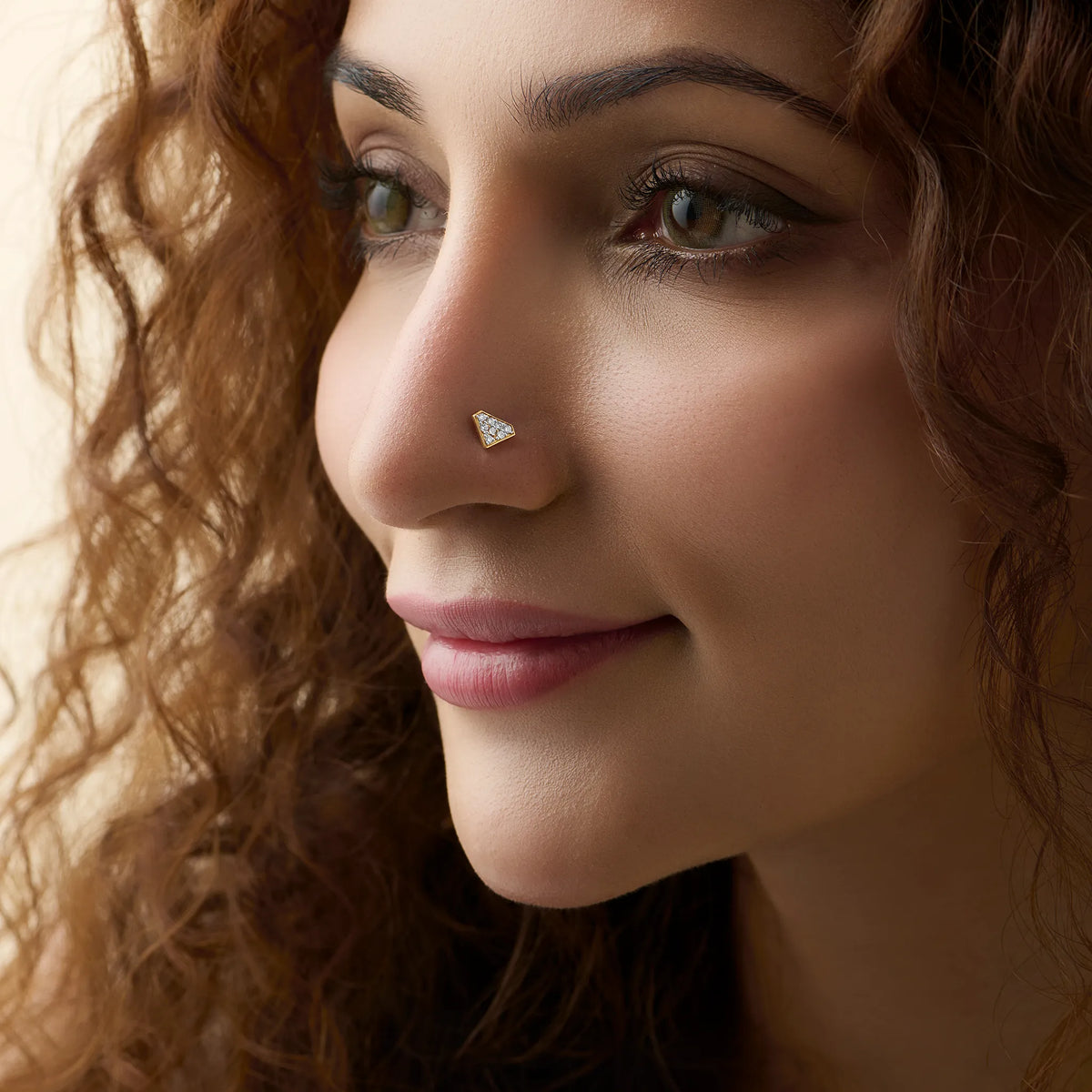 Woman wearing elegant gold diamond nose pin close-up portrait
