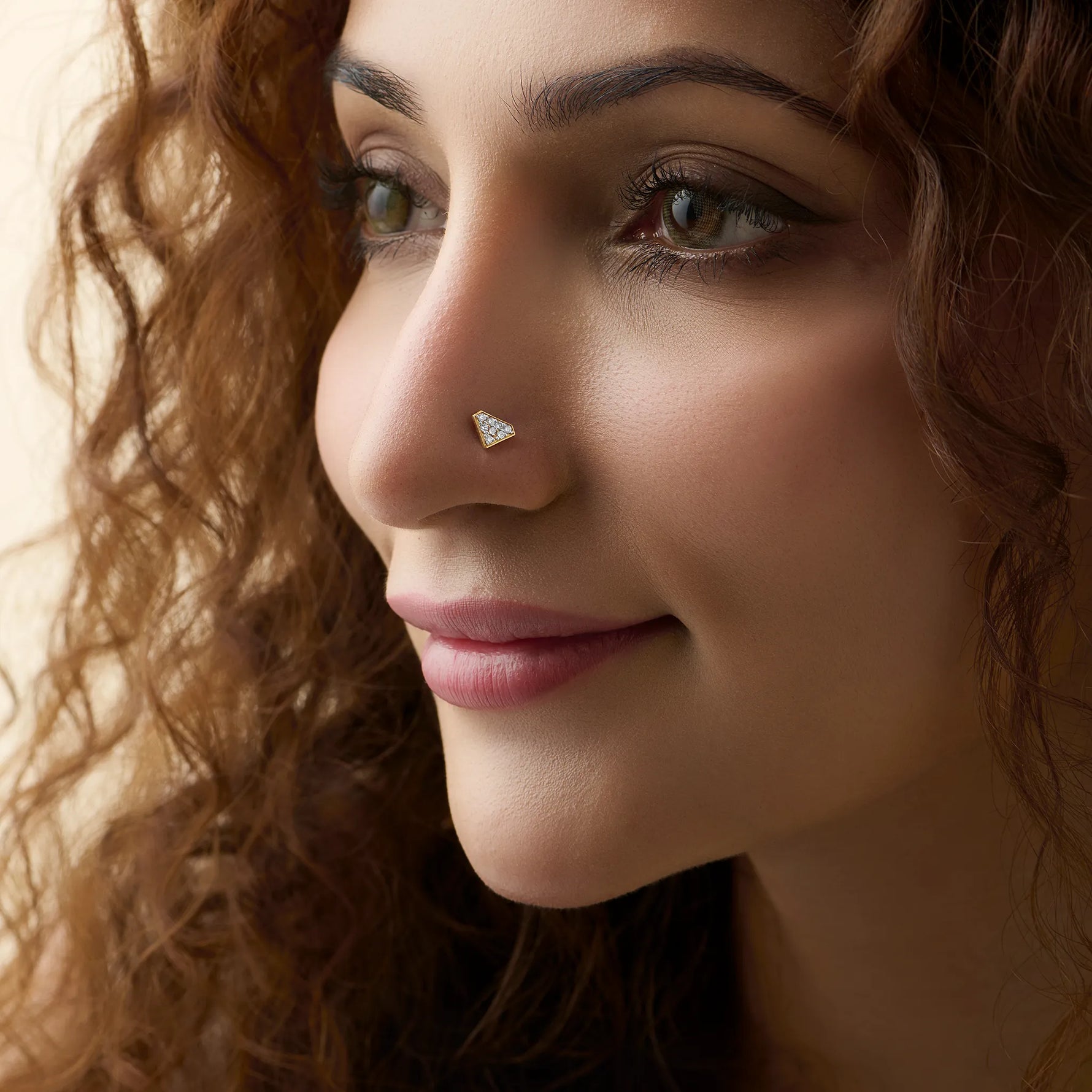 Woman wearing elegant gold diamond nose pin close-up portrait