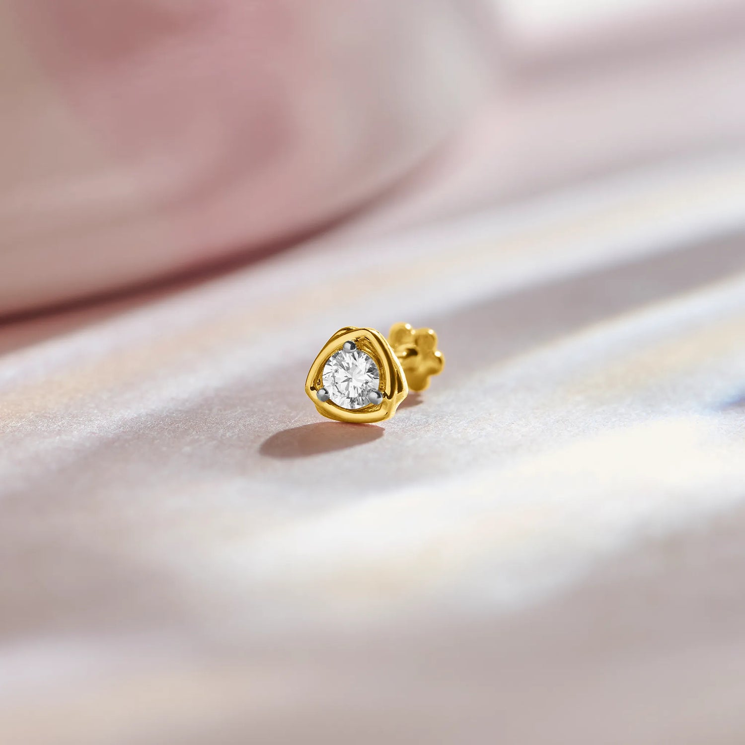 Round diamond stud earring with triangular gold bezel setting