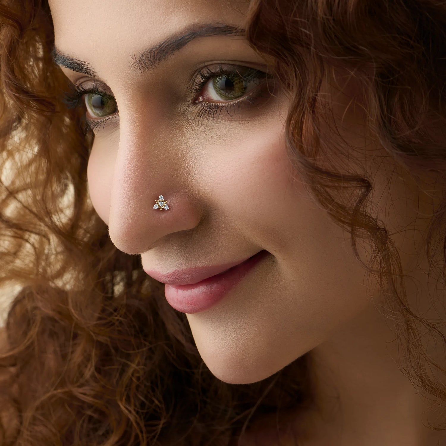 Woman wearing traditional gold nose pin close-up portrait