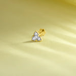 Lab grown diamond nose pin with three stone floral design in gold on soft yellow background