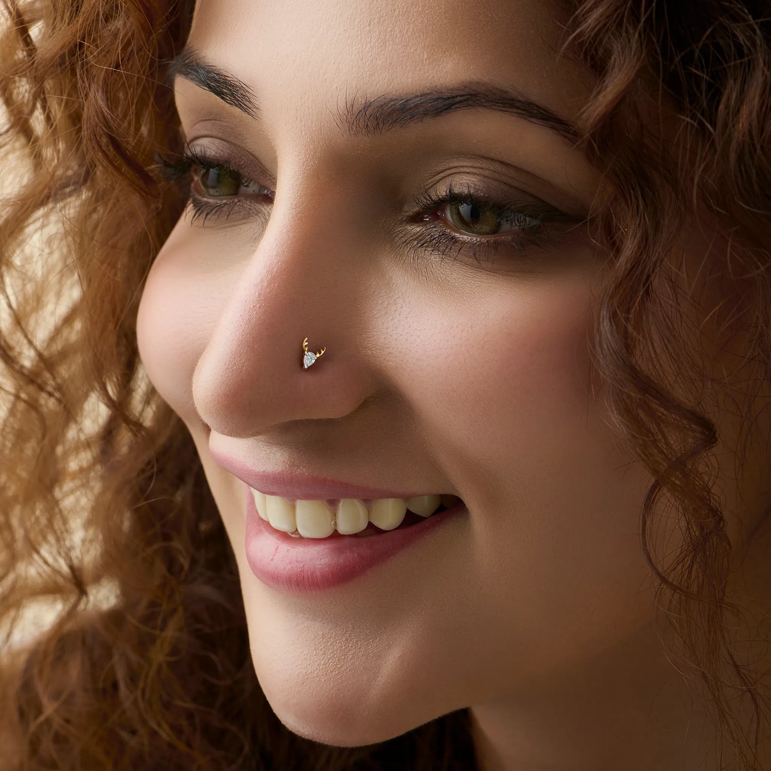 Woman wearing lab grown diamond nose pin with elegant minimal diamond style
