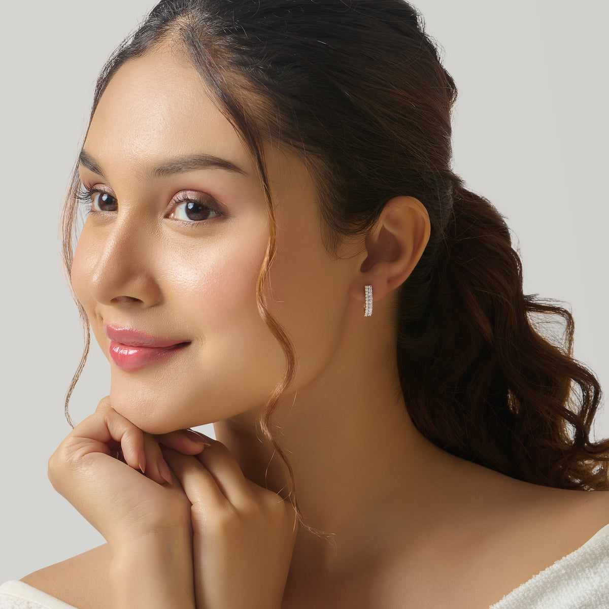 Close-up of woman wearing gold bar stud earring