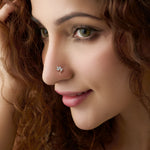 Close-up of woman wearing a nose stud with a three-leaf marquise diamond design
