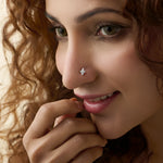 Woman wearing gold pin nose with elegant diamond floral style