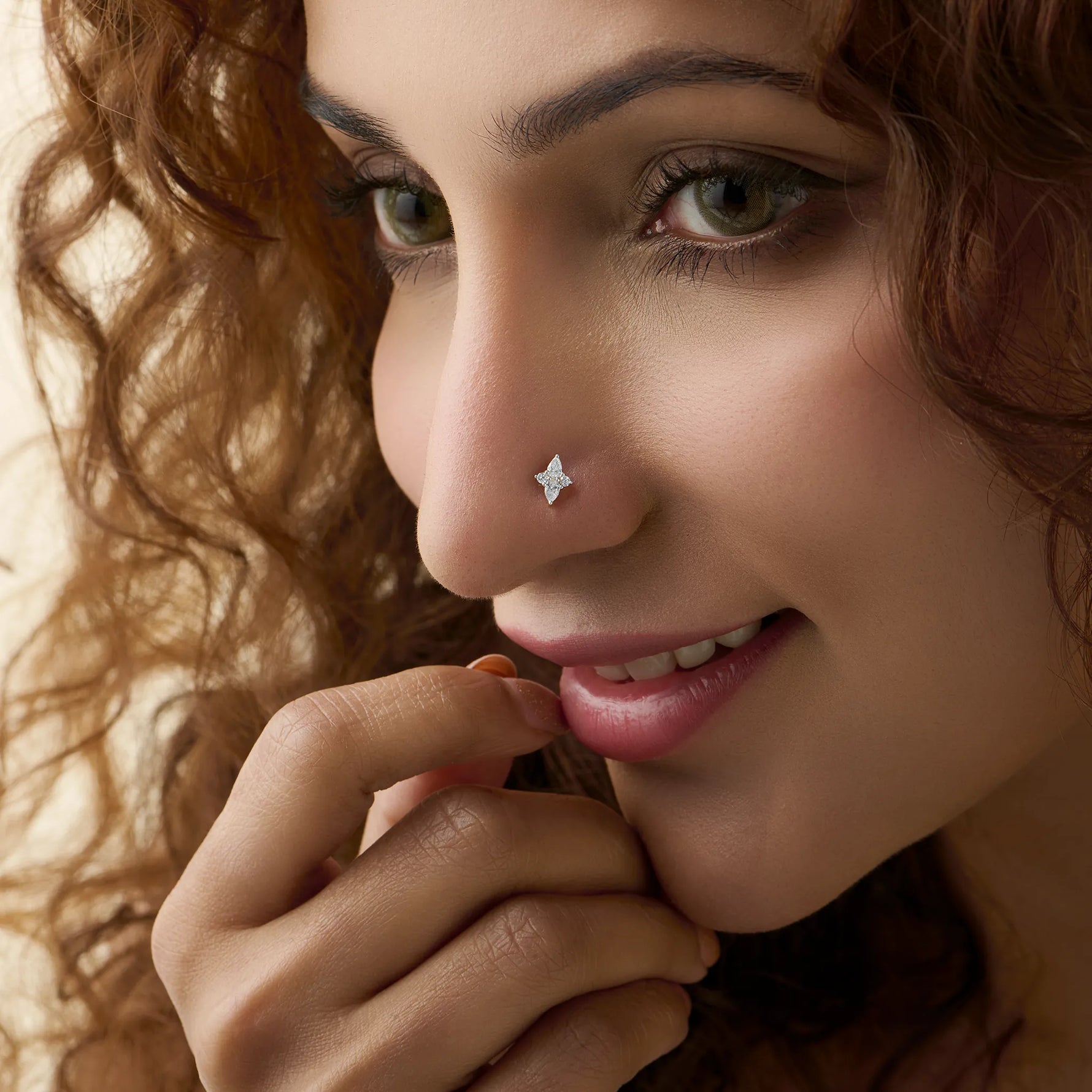 Woman wearing gold pin nose with elegant diamond floral style