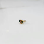 Women's gold nose pin design with gemstone floral setting on white background